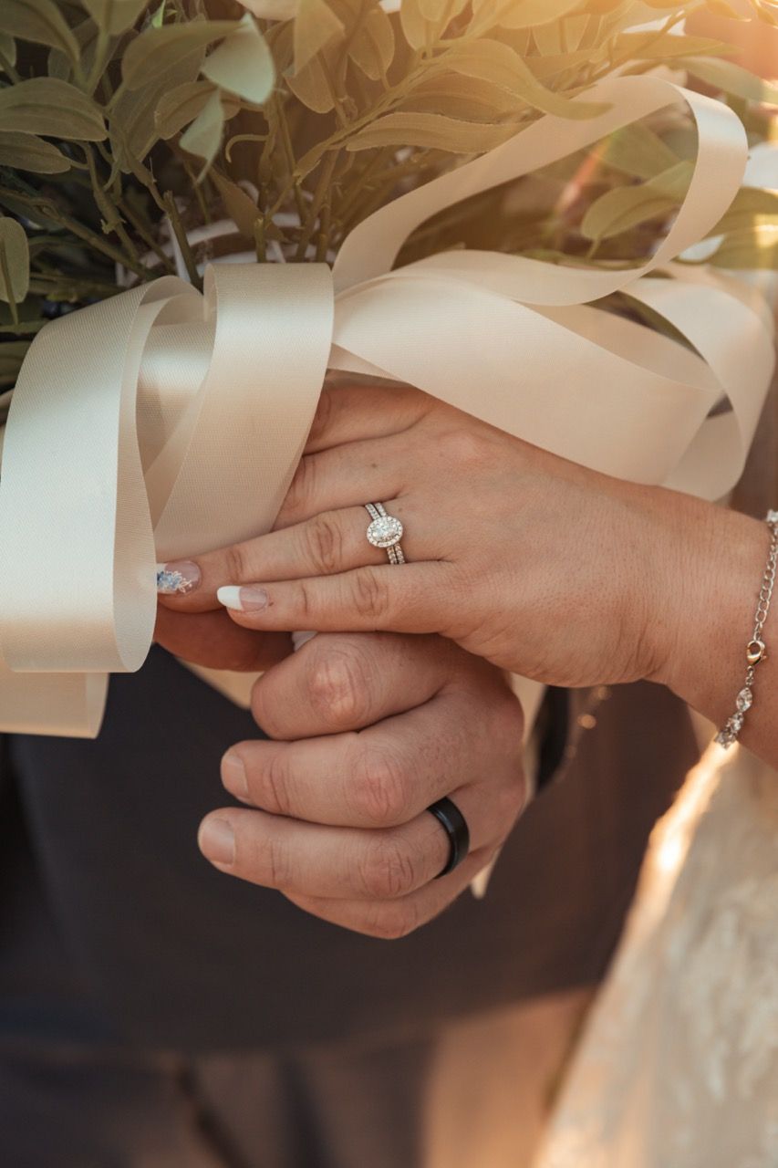 Close up of rings hands holding bouquet at wedding at Morgan Hill Event Center in Herman, Maine captured by illuminate the stars Photography