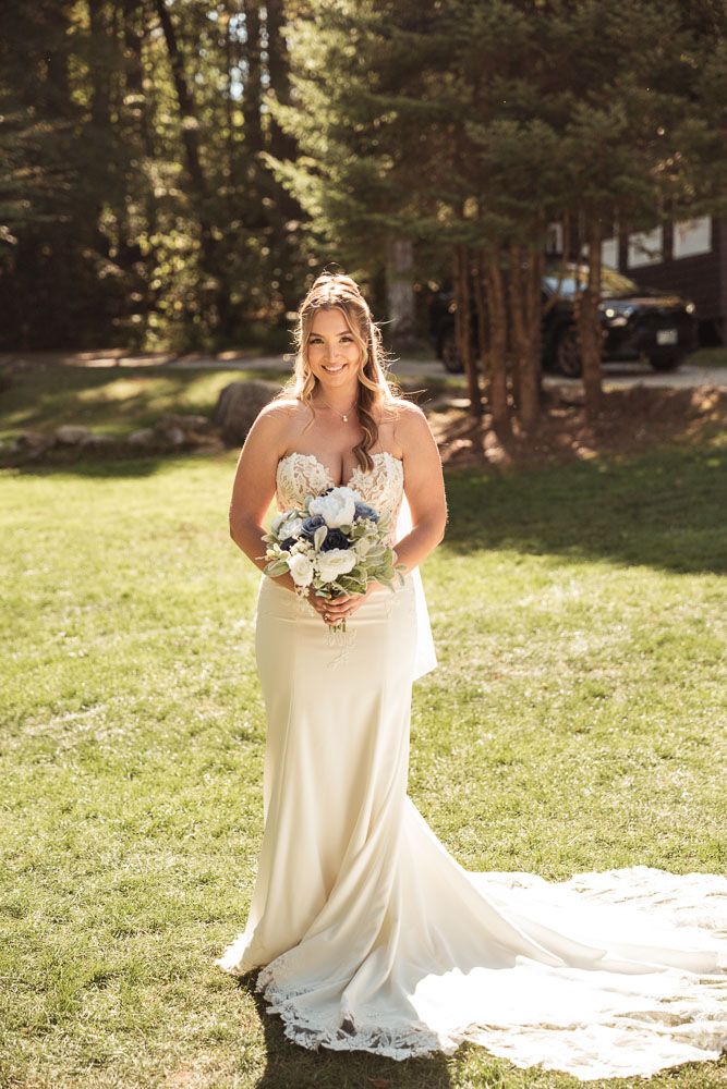 Bride in mermaid wedding dress during her fall wedding at Camp Waziyatah in Waterford, Maine captured by illuminate the stars Photography