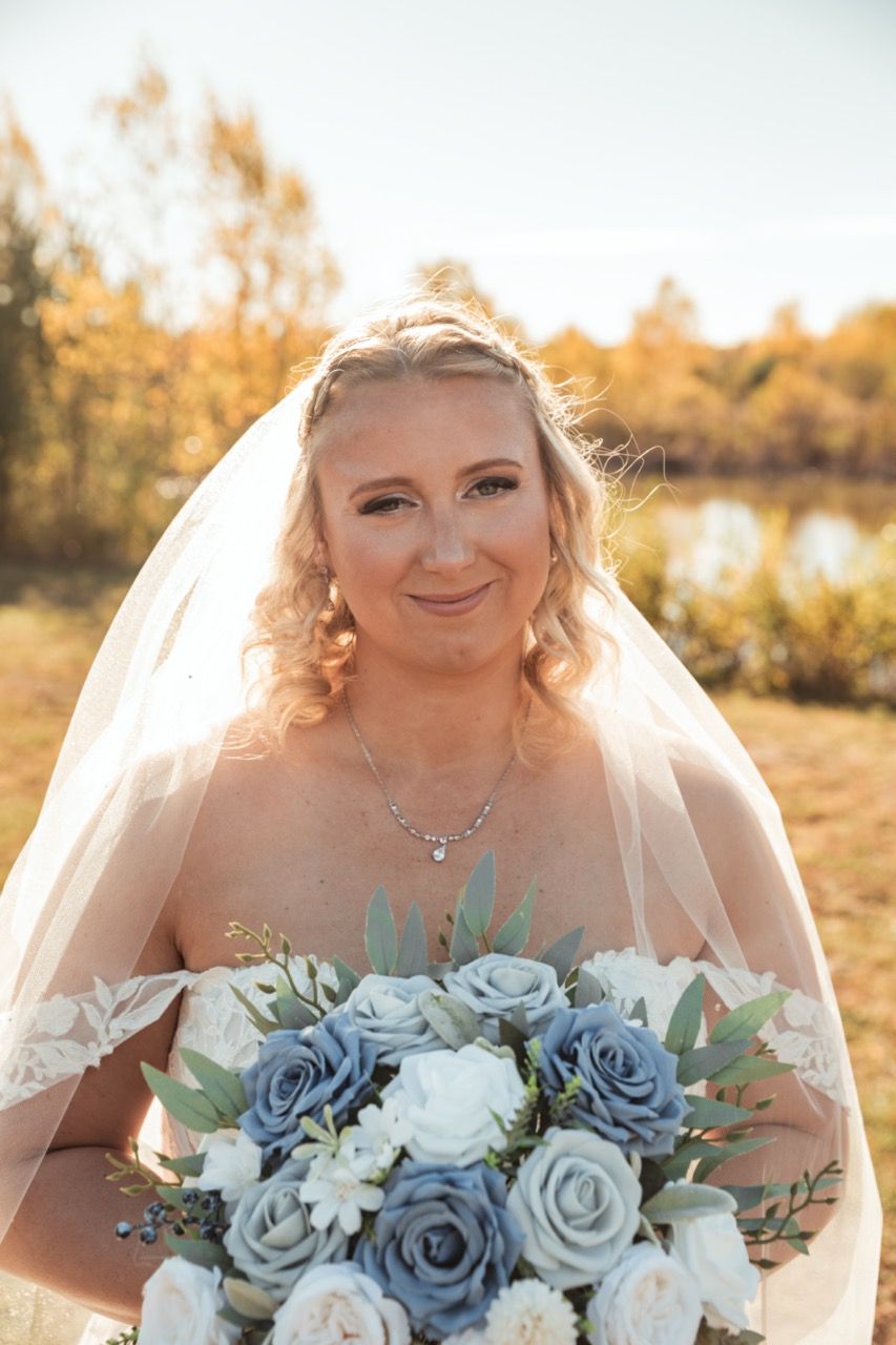 Bride soft smiling at with her bouquet at wedding at Morgan Hill Event Center in Herman, Maine captured by illuminate the stars Photography
