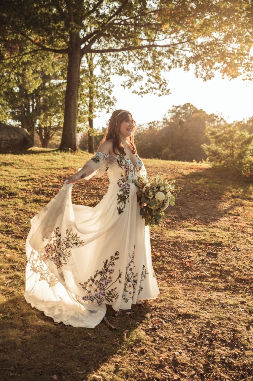 Bride twirling in dress at wedding at June Norcross Webster Scout Reservation in Ashford, CT captured by illuminate the stars Photography