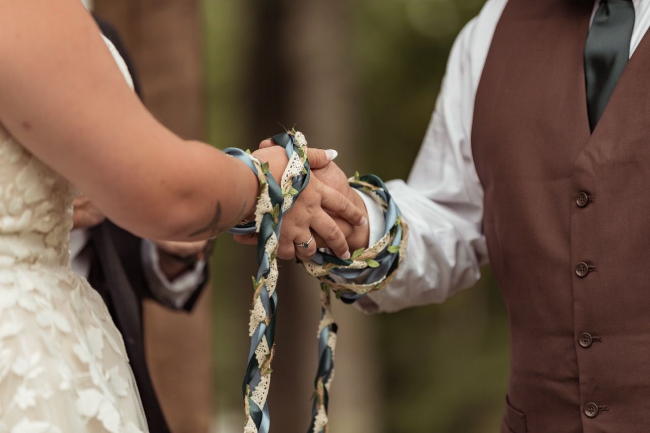 Couple tying the knot during fall wedding ceremony at The Lakeside Lodge in Sydney, Maine captured by illuminate the stars Photography