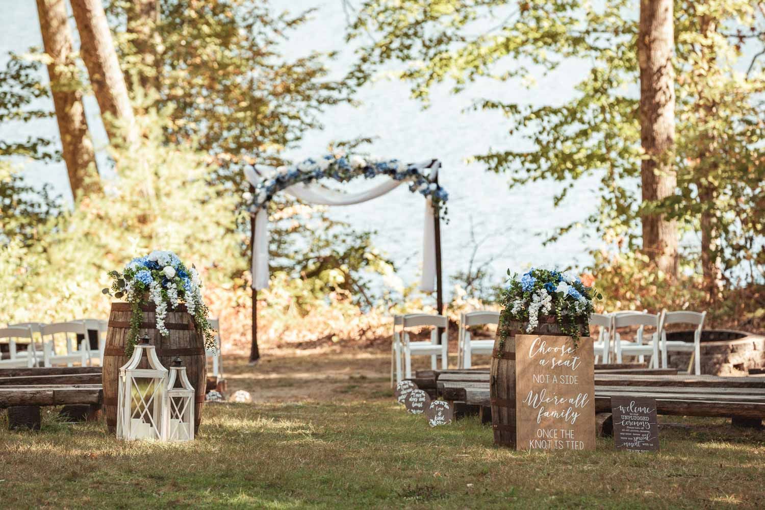 Wedding ceremony site with arch for a wedding at Camp Waziyatah in Waterford, Maine at captured by illuminate the stars Photography