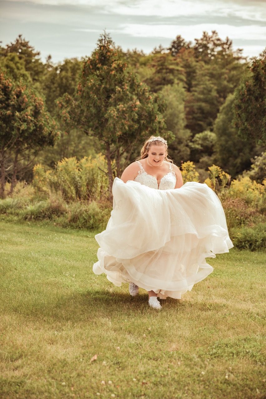 Bride running through field before her fall wedding at Camp Dudley in Westport, New York captured by illuminate the stars Photography