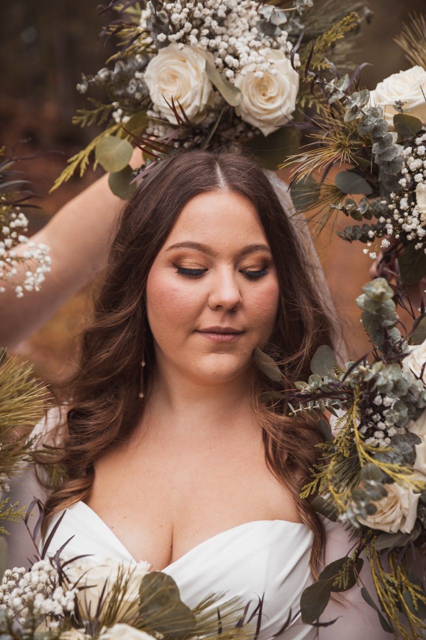 Bride and flowers for winter wedding at Sugarloaf Mountain Resort in Carrabassett Valley, Maine captured by illuminate the stars Photography