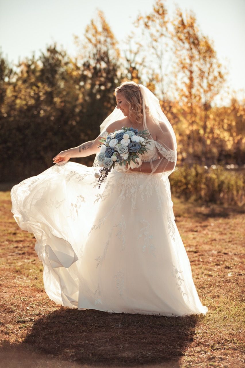 Bride tossing wedding dress at sunset for wedding at Morgan Hill Event Center in Herman, Maine captured by illuminate the stars Photography