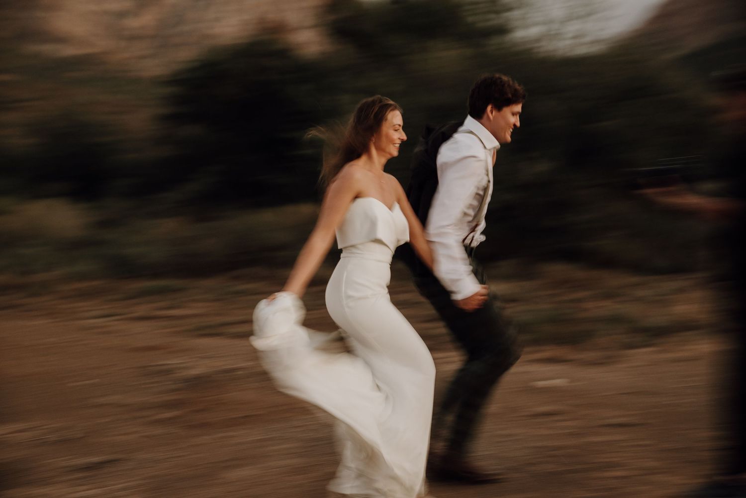 wedding couple running slow shutter speed motion blur Swartberg Pass Prince Albert South Africa Karoo Plain Blue Wedding Photo & Film Studio
