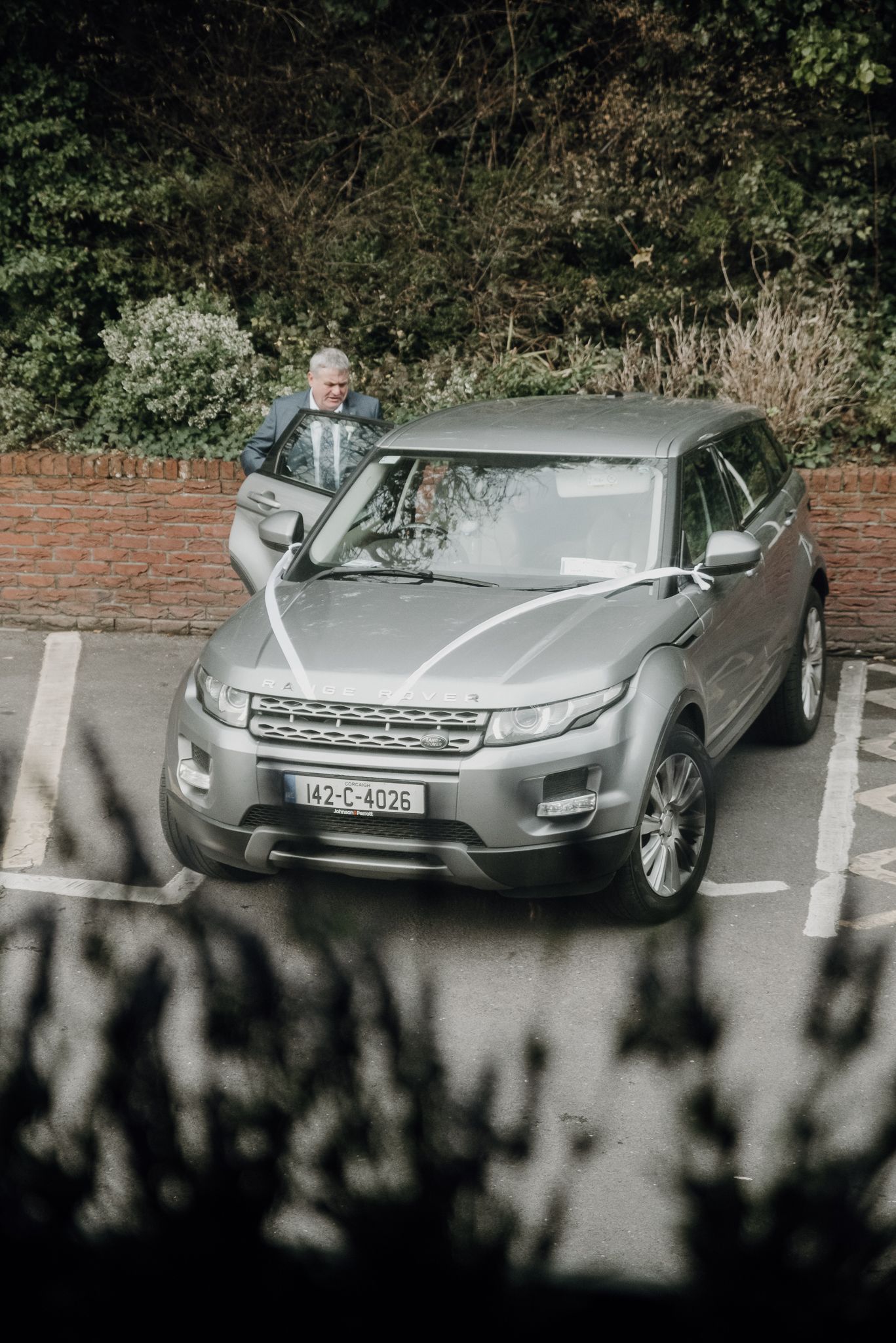 Bride's father with the wedding car ahead of Aisling's ceremony in Killarney