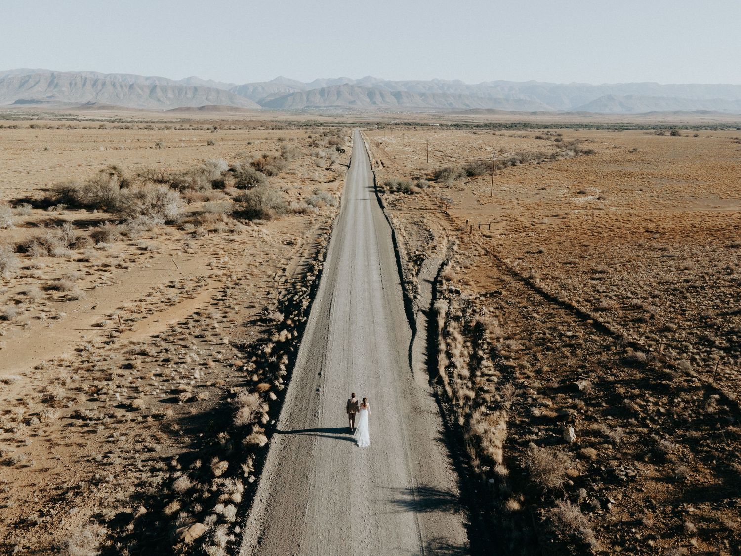 Drone Aerial photograph of wedding couple on dirt gravel road outside Prince Albert in the Karoo