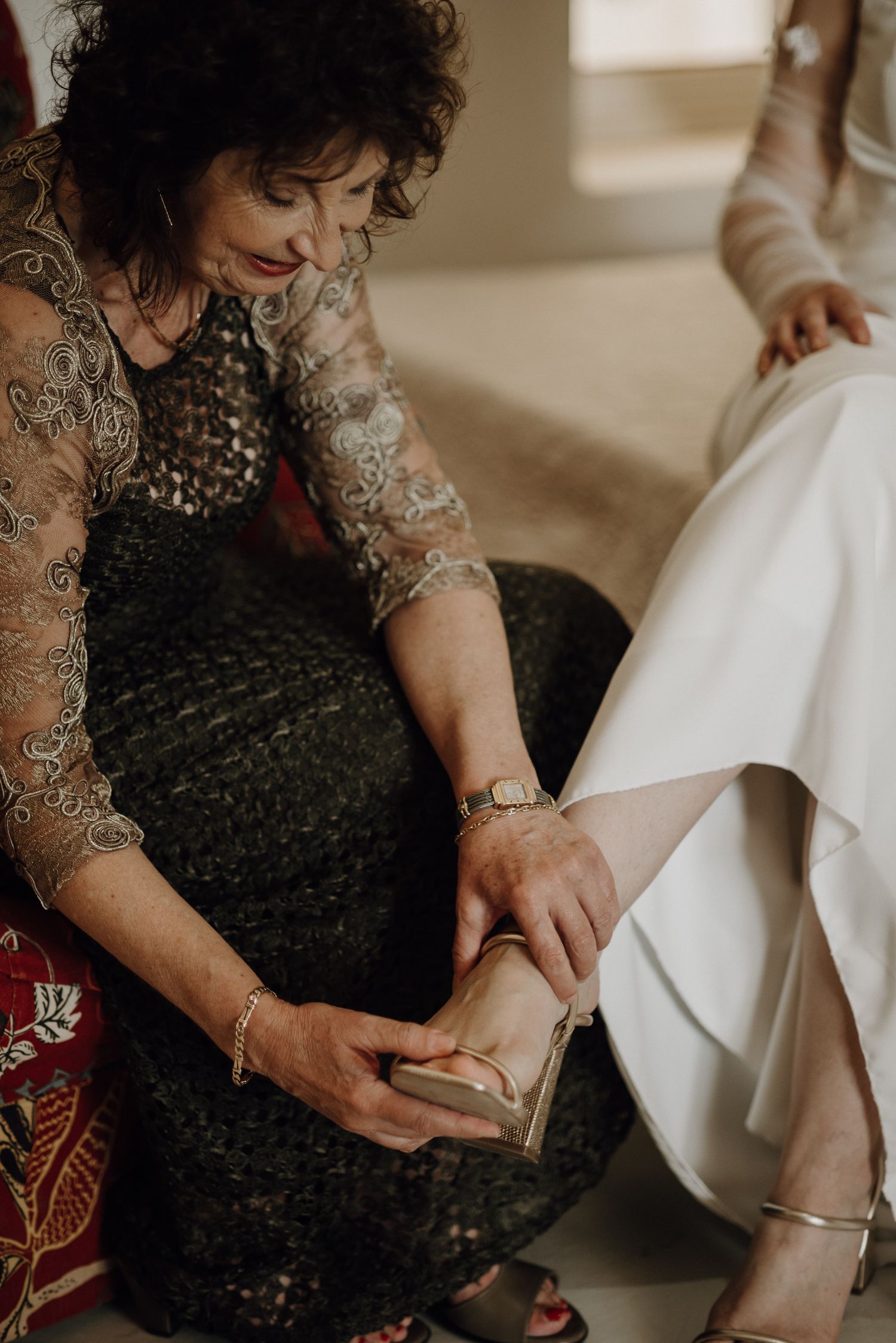 Bride's mother helping bride put on her shoes for Prince Albert destination wedding at Olive House