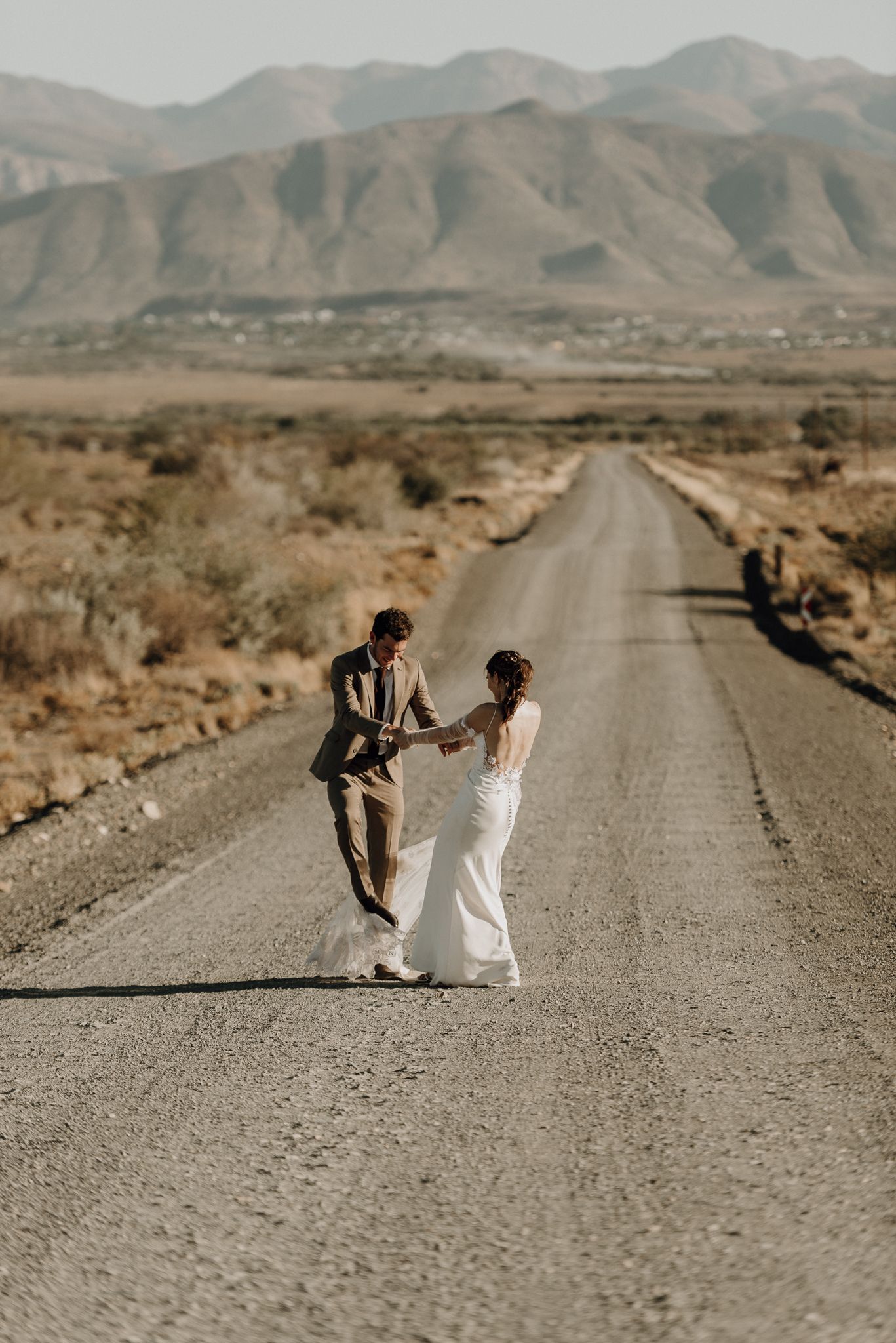 couple dancing on gravel road Swartberg Mountain Prince Albert Karoo South Africa documentary romantic Plain Blue Wedding Photo & Film