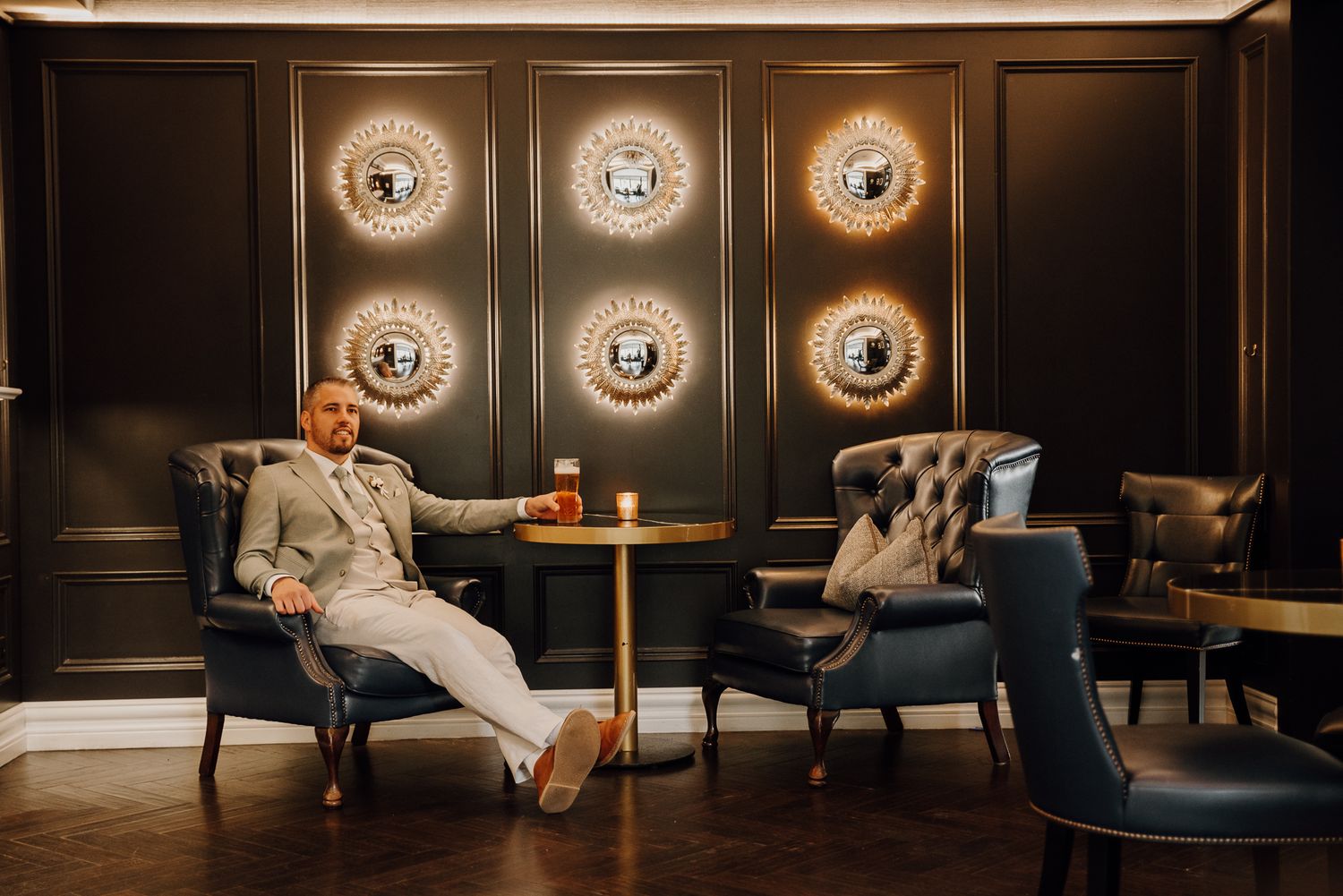 Groom Johann posing for portraits in the bar area of Randles Hotel, Killarney