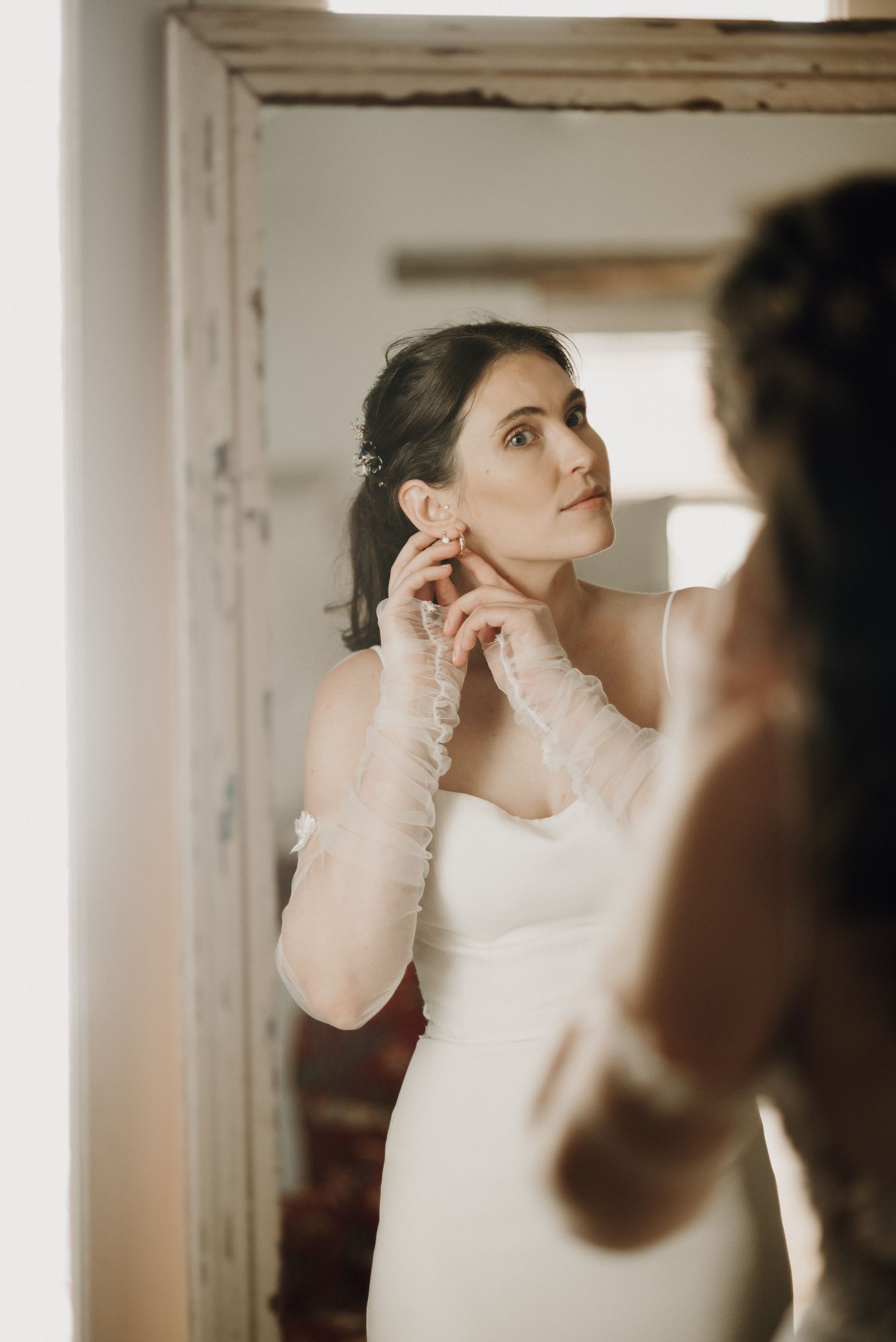 Bride looking in mirror getting ready for Prince Albert destination wedding