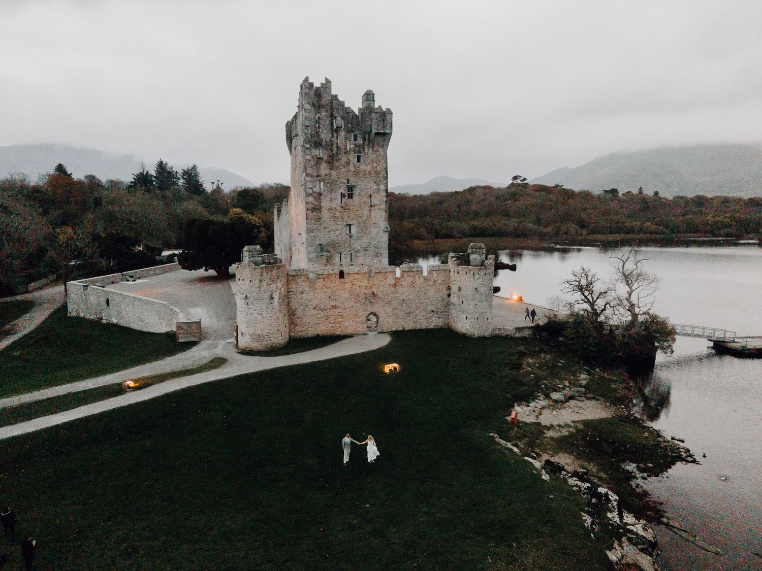 Ross Castle Killarney Ireland wedding couple lake moody overcast drone editorial international Plain Blue International Wedding Photo & Film