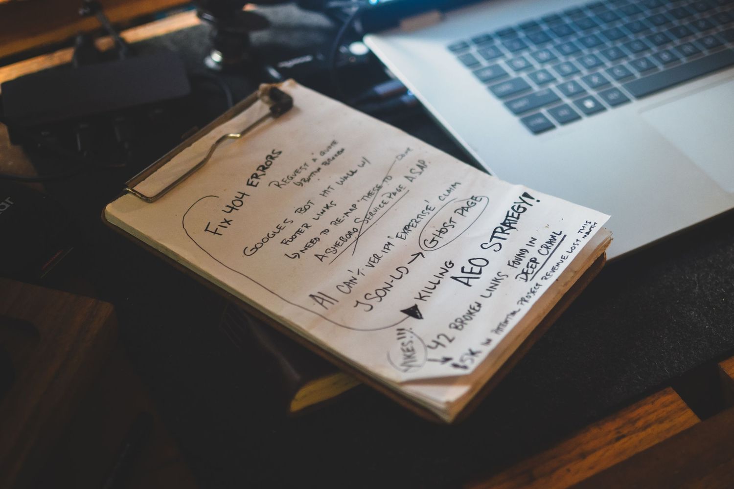 Handwritten field notes on a desk in Asheboro diagnosing 404 errors and revenue leaks for a contractor website strategy.