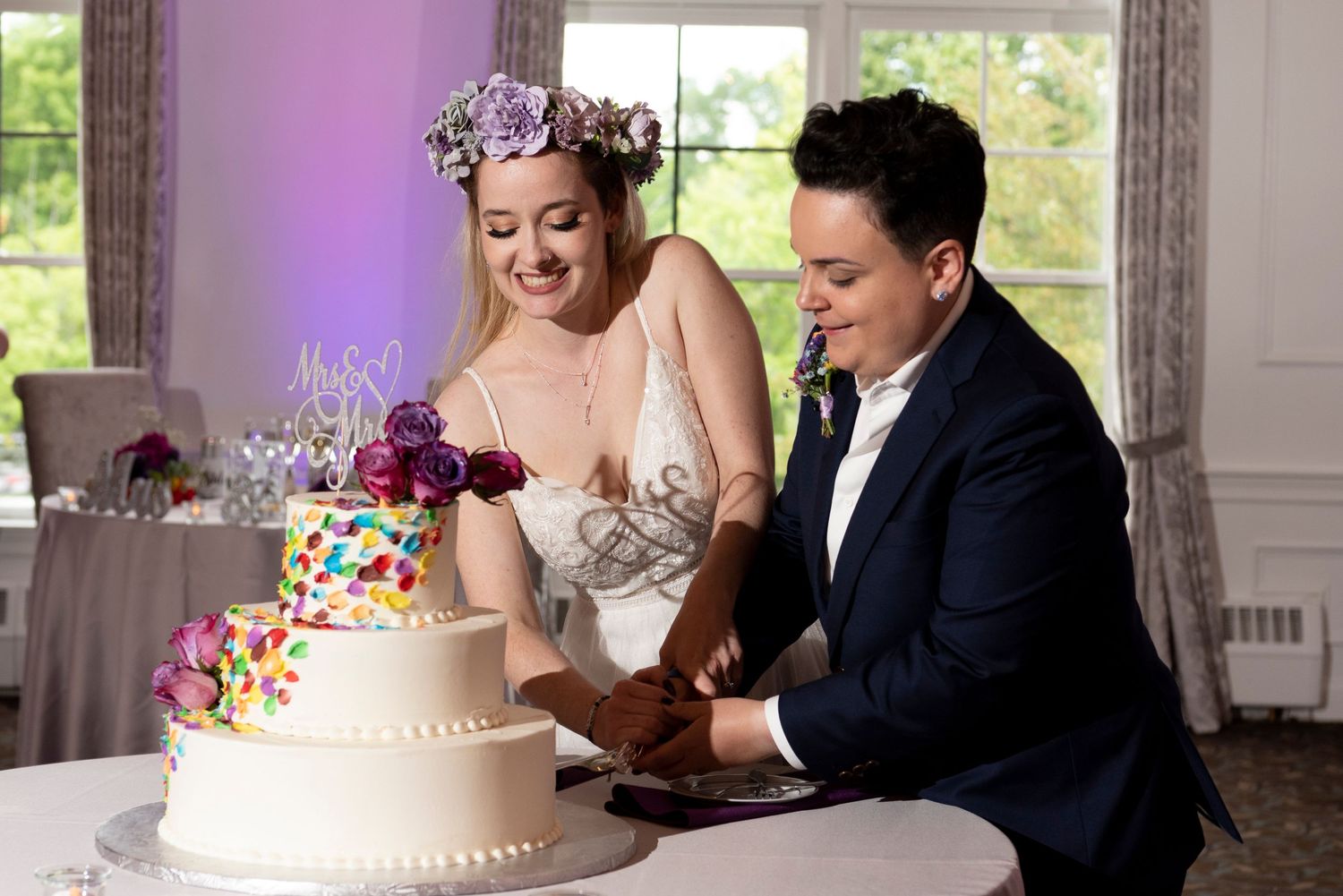 LGBTQ+ wedding photograph capturing joyful and authentic moments between two brides.