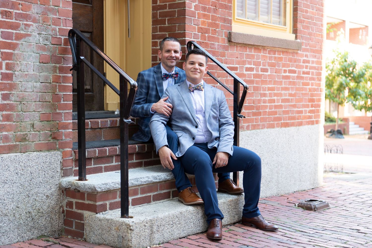 Romantic LGBTQ+ wedding portrait featuring two grooms during golden hour.