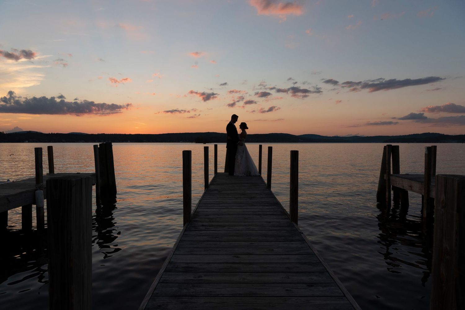 Lakeside wedding photography at Lake Winnipesaukee with candid and romantic moments.
