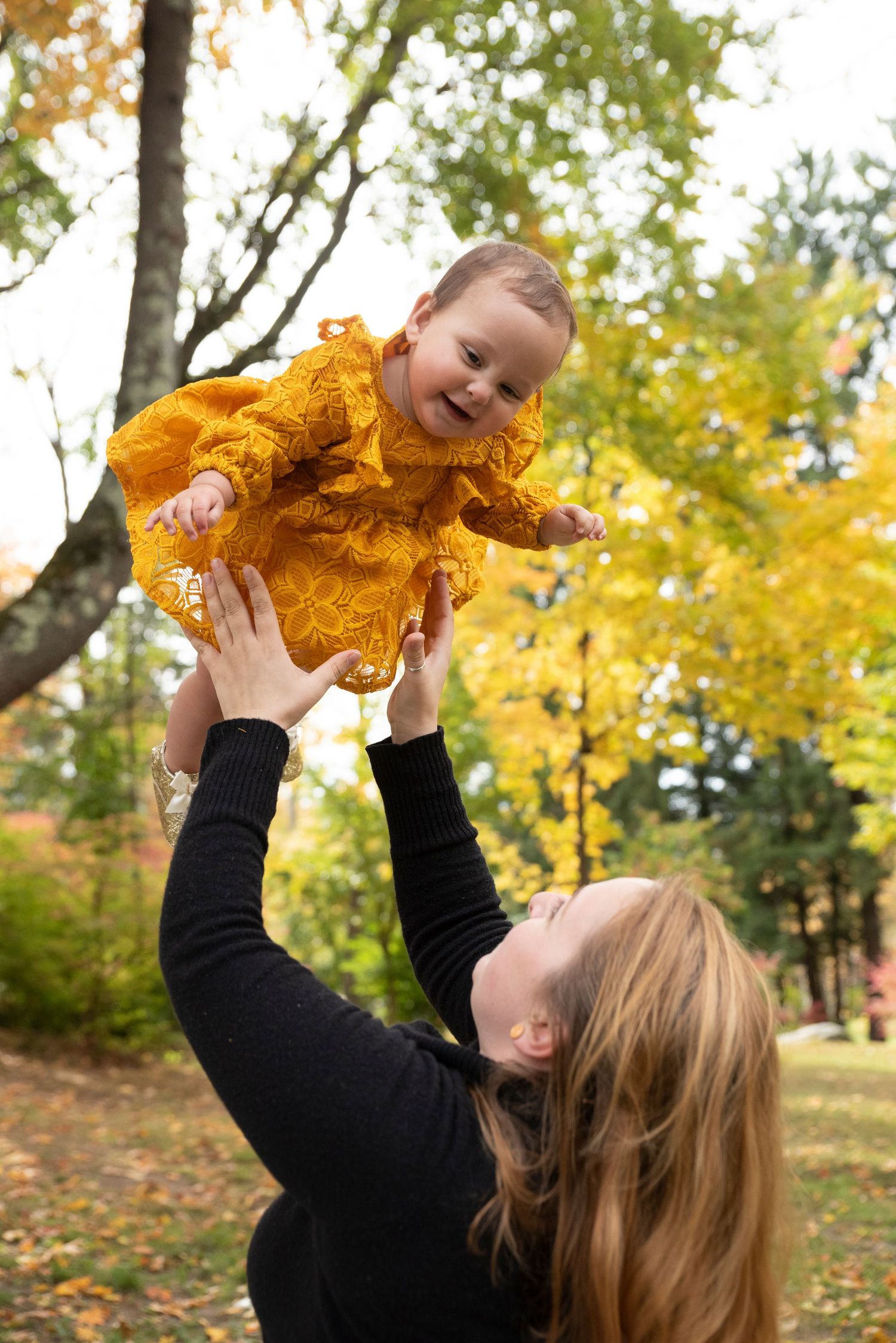 Family photo session outdoors in New Hampshire with natural light and candid smiles.