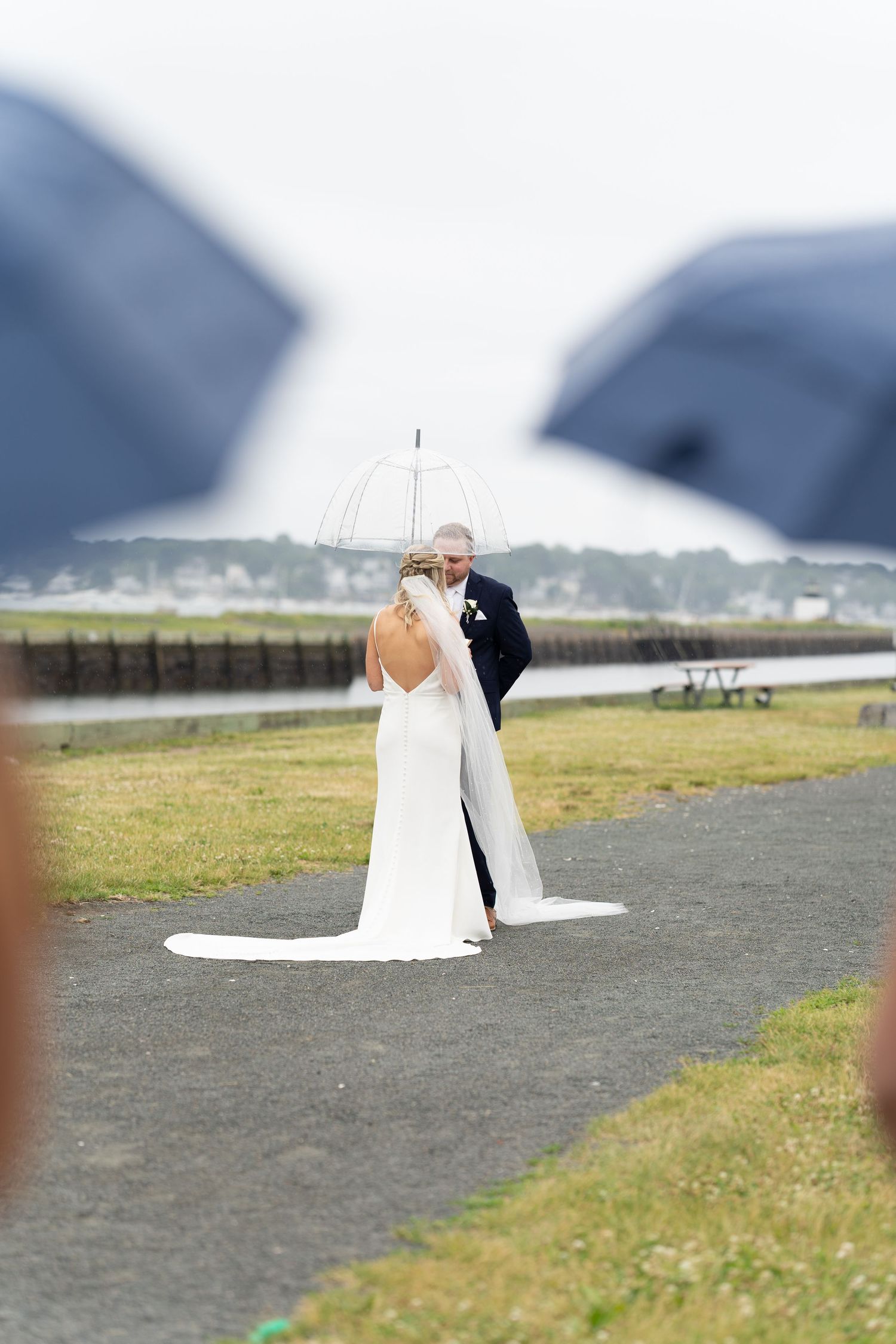 Joyful rainy wedding photo celebrating love in every weather.