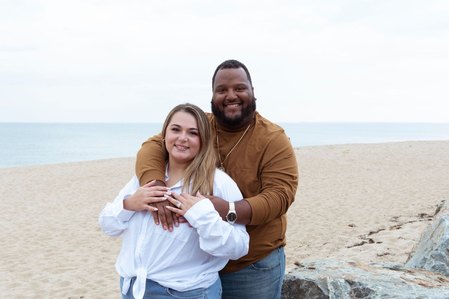 Couple sharing a romantic moment during a beach engagement session.