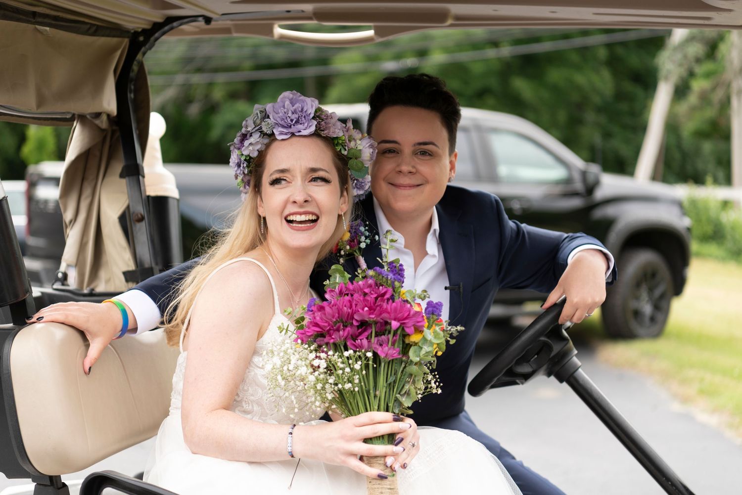 Candid LGBTQ+ wedding photo showing laughter and love during the reception.