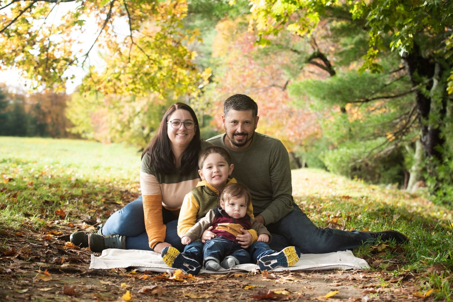 Outdoor family photography session near a New Hampshire lake with warm evening light.