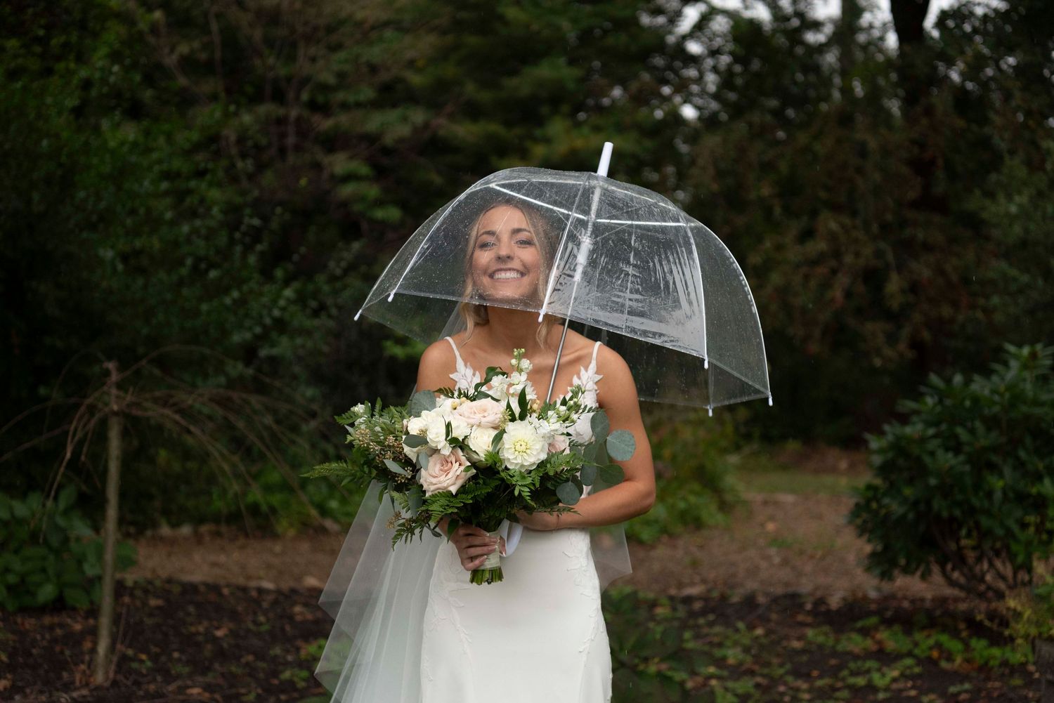 Candid rainy wedding photography highlighting love and laughter despite the weather.