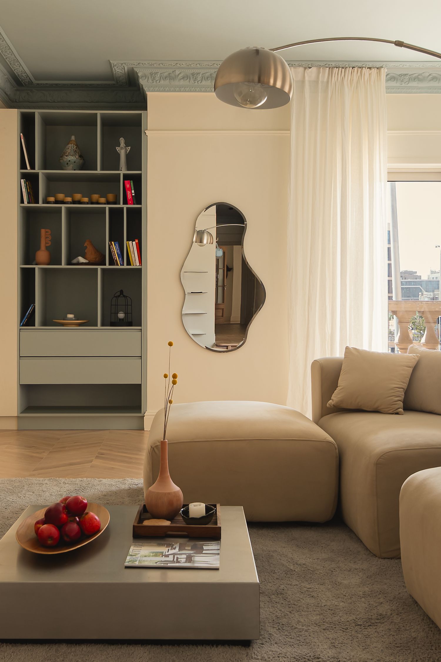 Contemporary living room with beige sectional sofa and built-in shelving. Interior Photography