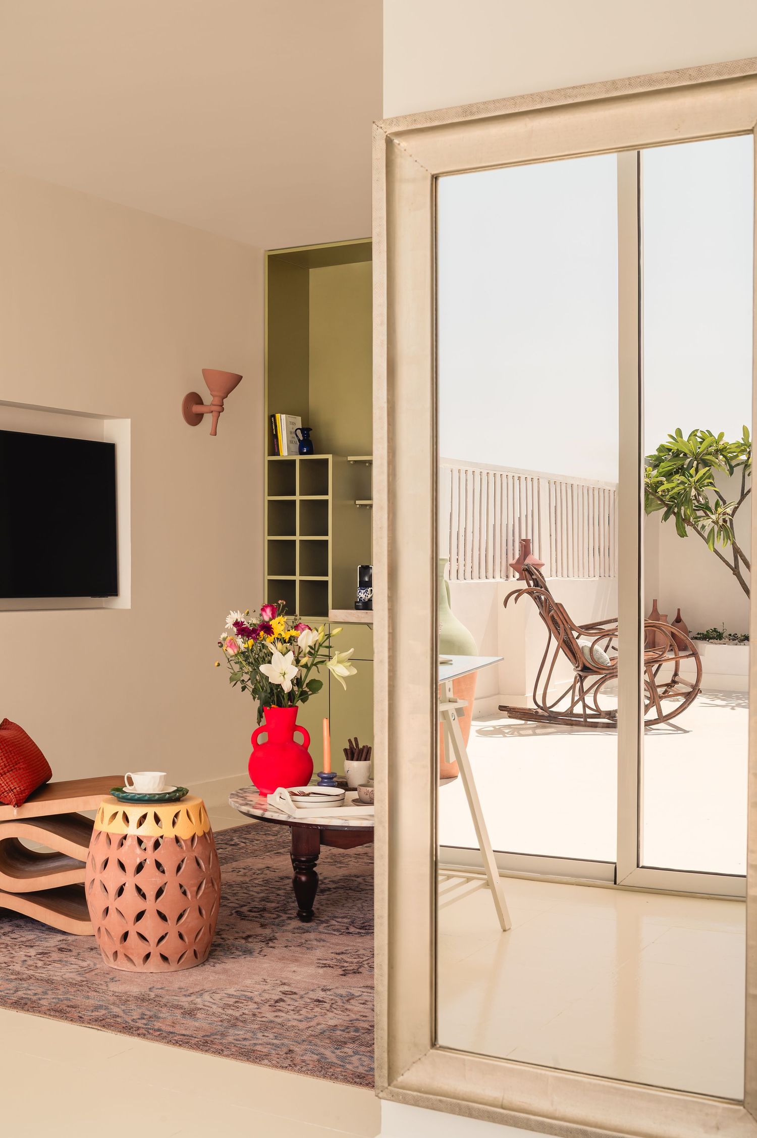 Modern living space with sliding glass doors and decorative terracotta planters. Interior Photography