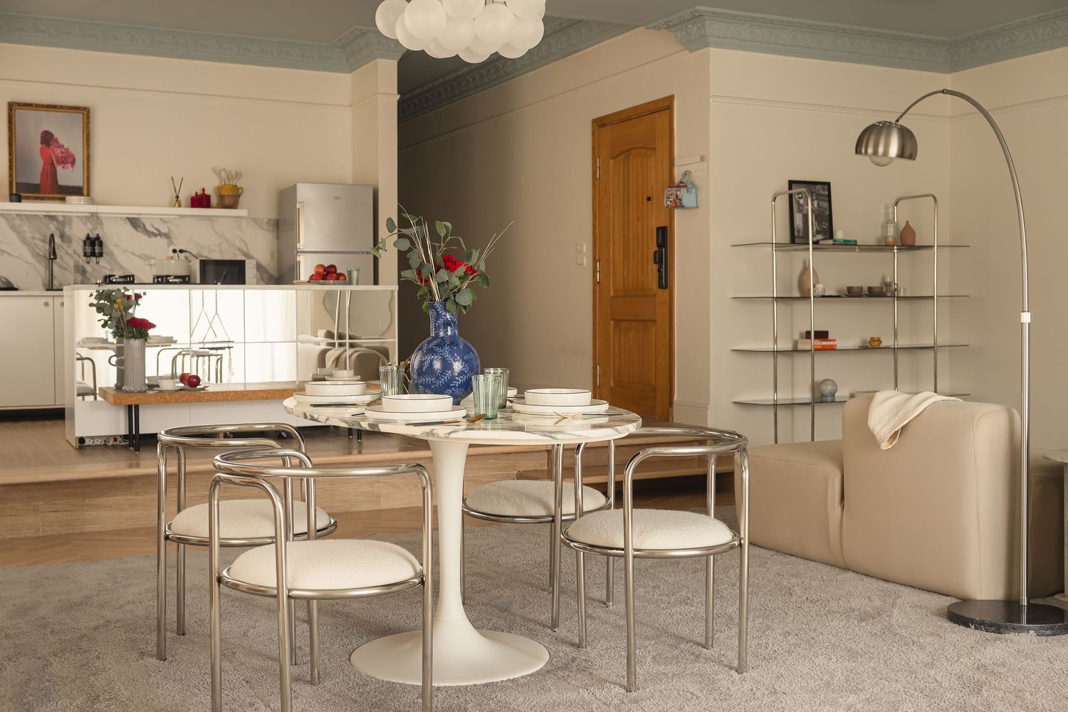 Mid-century modern dining room with tulip table, metal chairs, and built-in shelving. Interior Photography