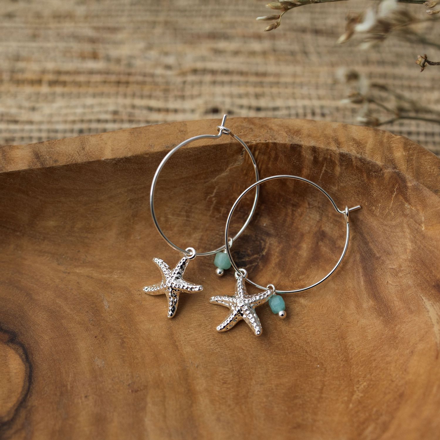 Handmade silver starfish and turquoise bead bracelet shown in multiple angles on a rustic wooden surface.