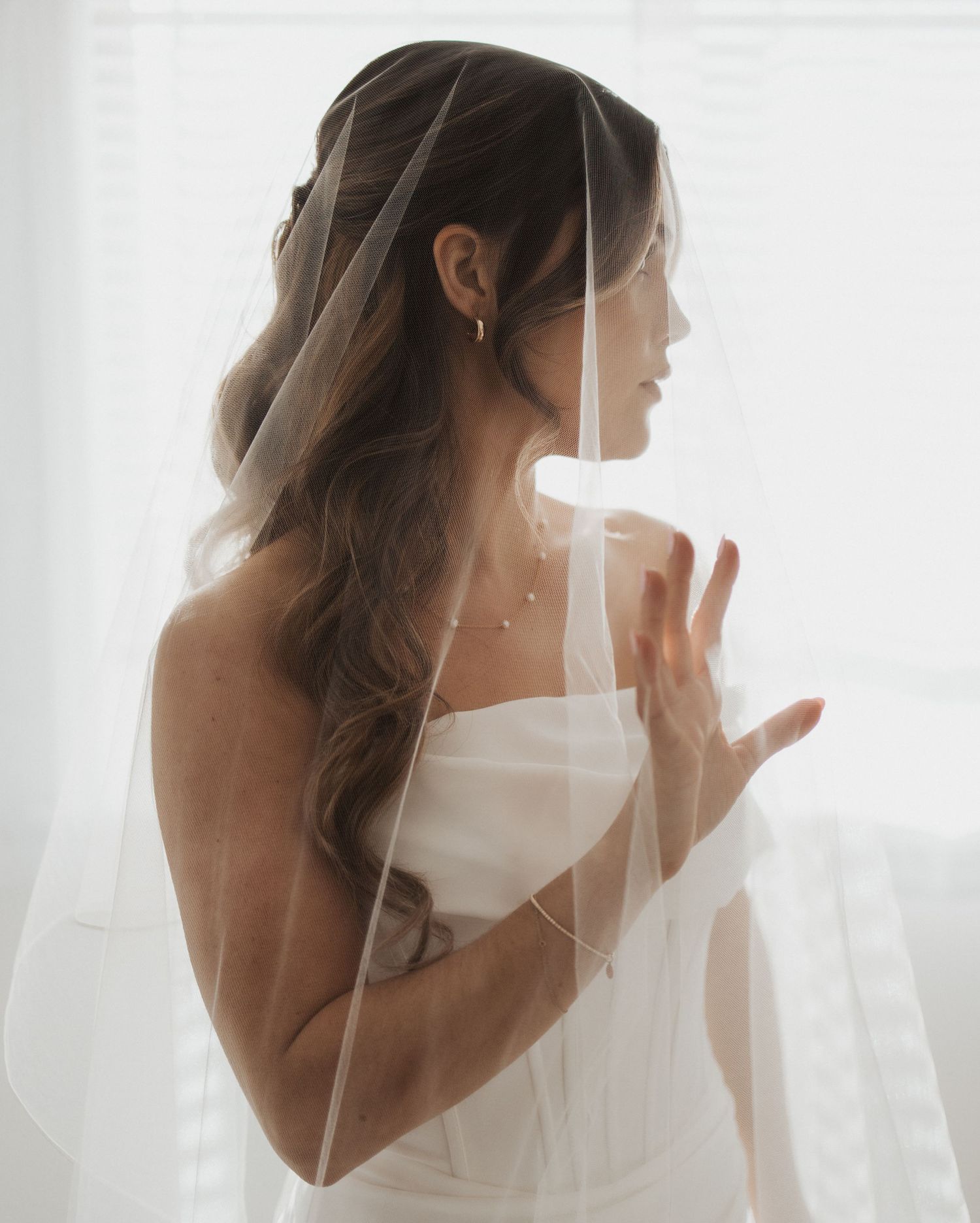 A series of ethereal bridal portraits showing a figure in white behind a flowing veil in soft natural light.