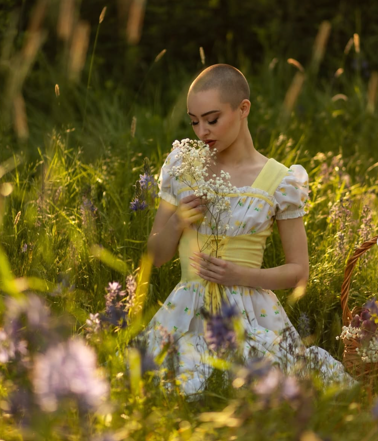 Classical floral dress silhouette poses amidst wildflowers in golden afternoon light.