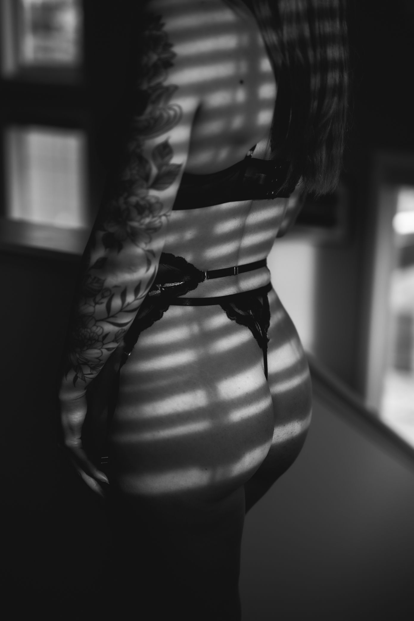 Dramatic black and white photo series showing light and shadow patterns cast through window blinds onto a wall.