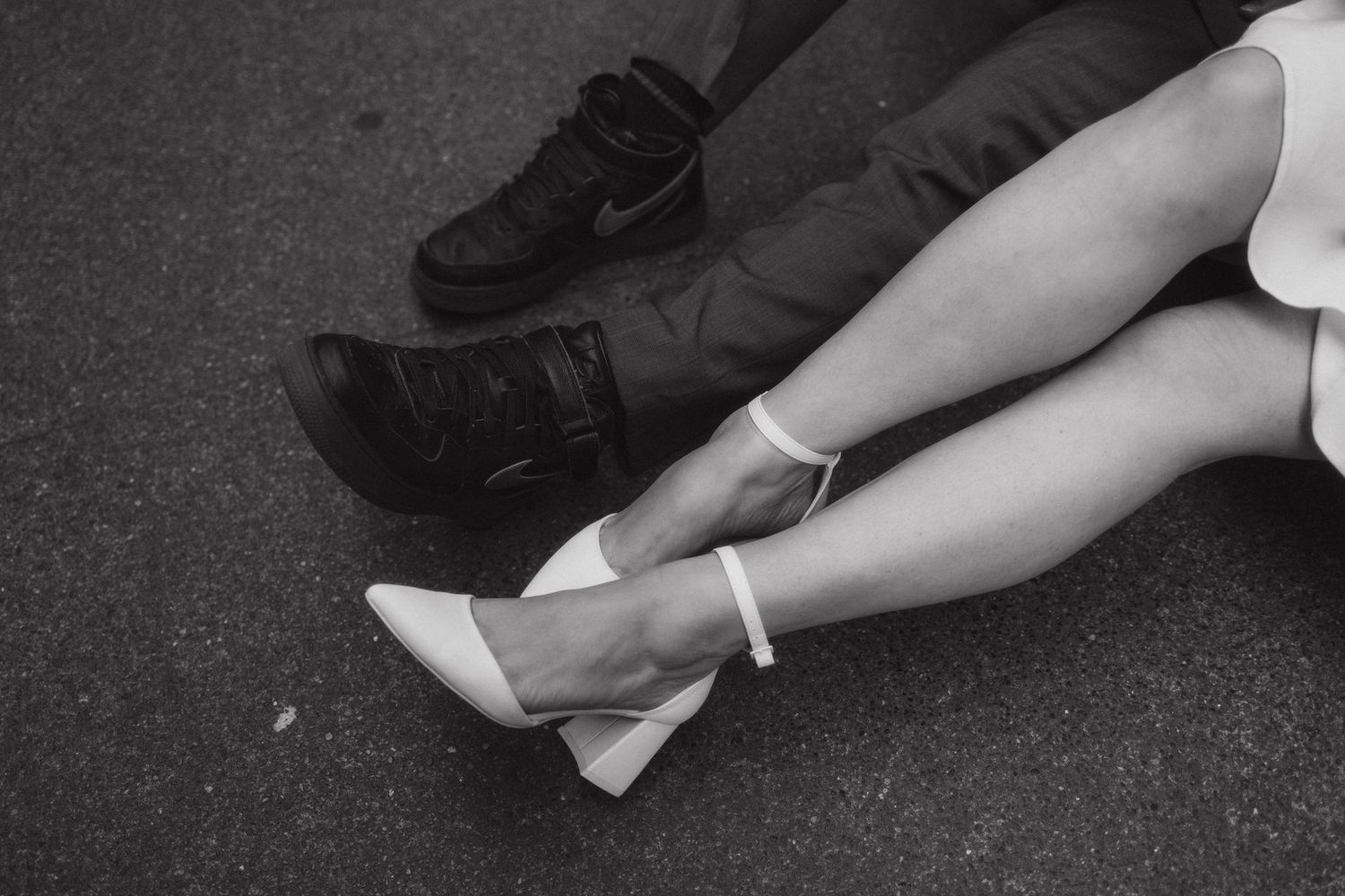 A sequence of black and white photos showing a person falling down on pavement in progressive motion.