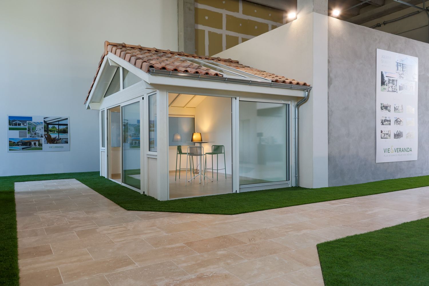 Mediterranean-style veranda display with terracotta roof tiles and glass walls in showroom setting.
