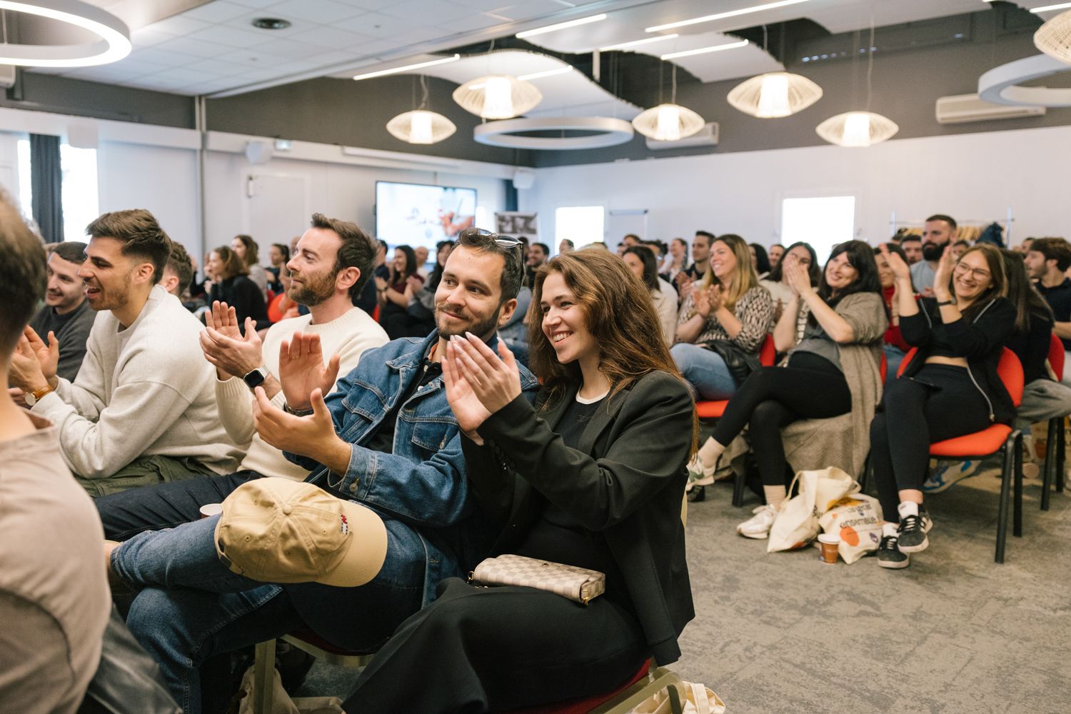 Engaged audience members sitting in rows during a business presentation or conference.