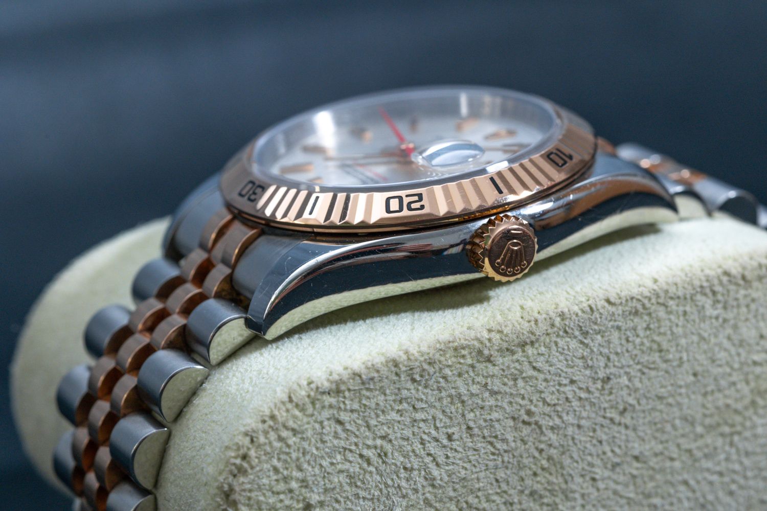 Close-up detail shot of a luxury watch showcasing its rose gold and steel bracelet design.
