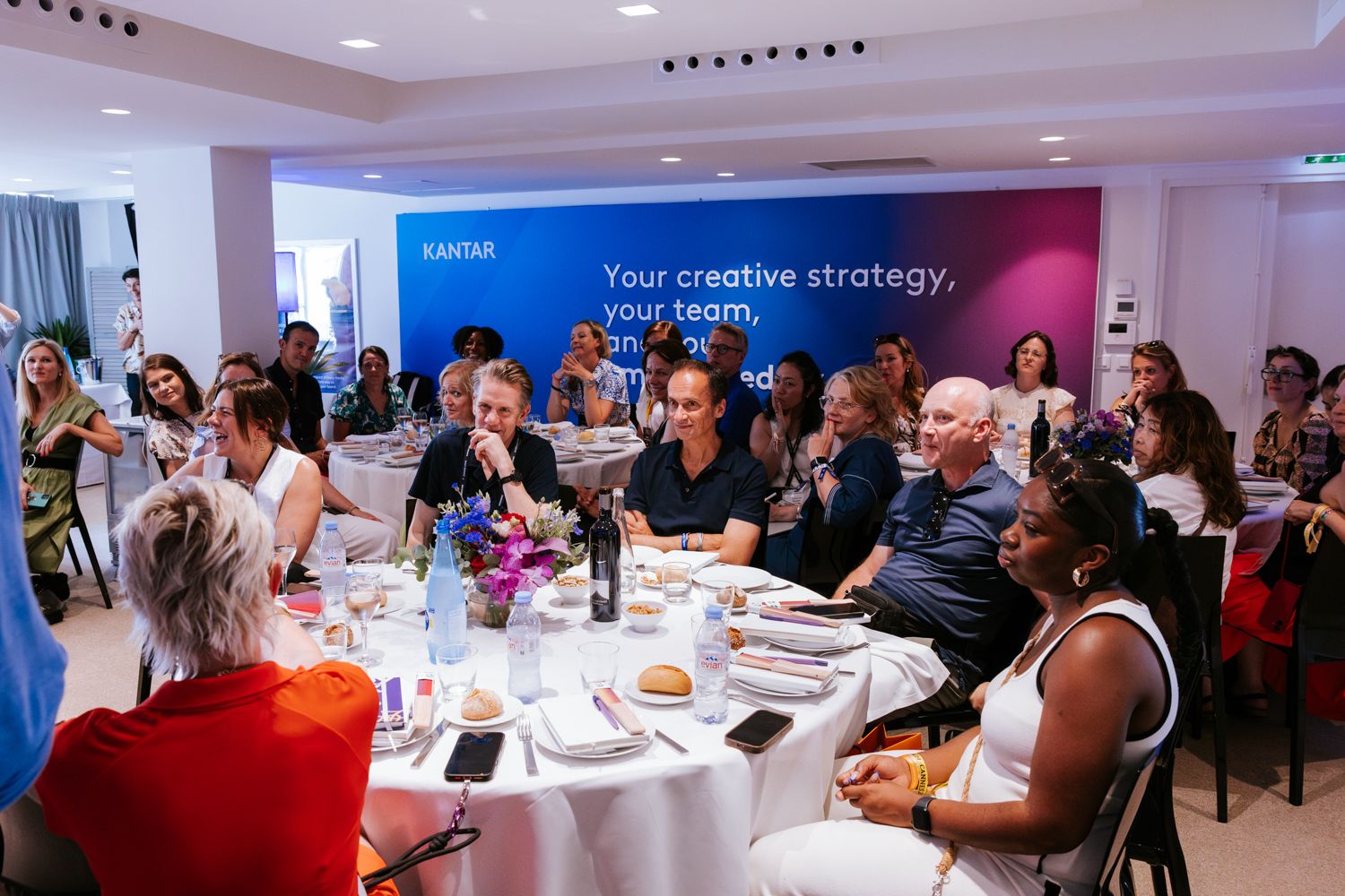 Business professionals participate in a collaborative workshop session in a modern conference room setting.
