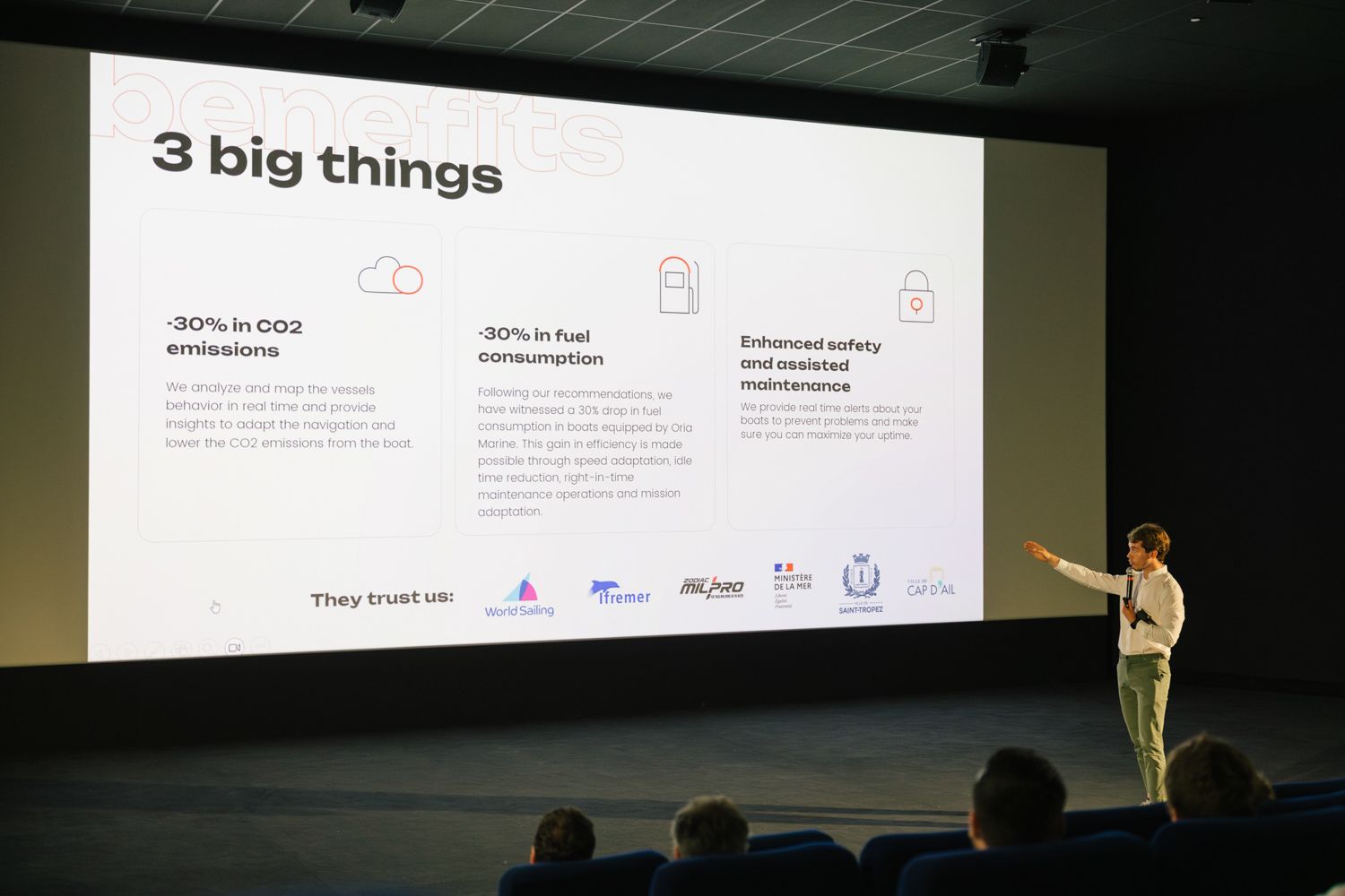 Presenter showing slide with three key points during business presentation.