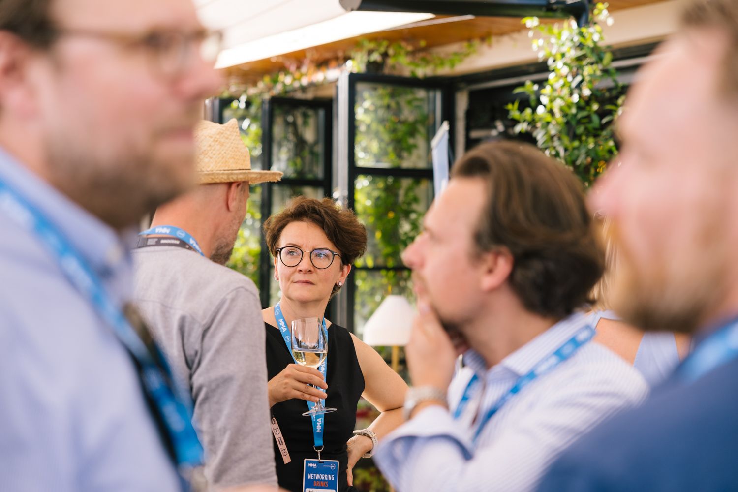 Business conference attendees network and socialize during a casual outdoor reception.