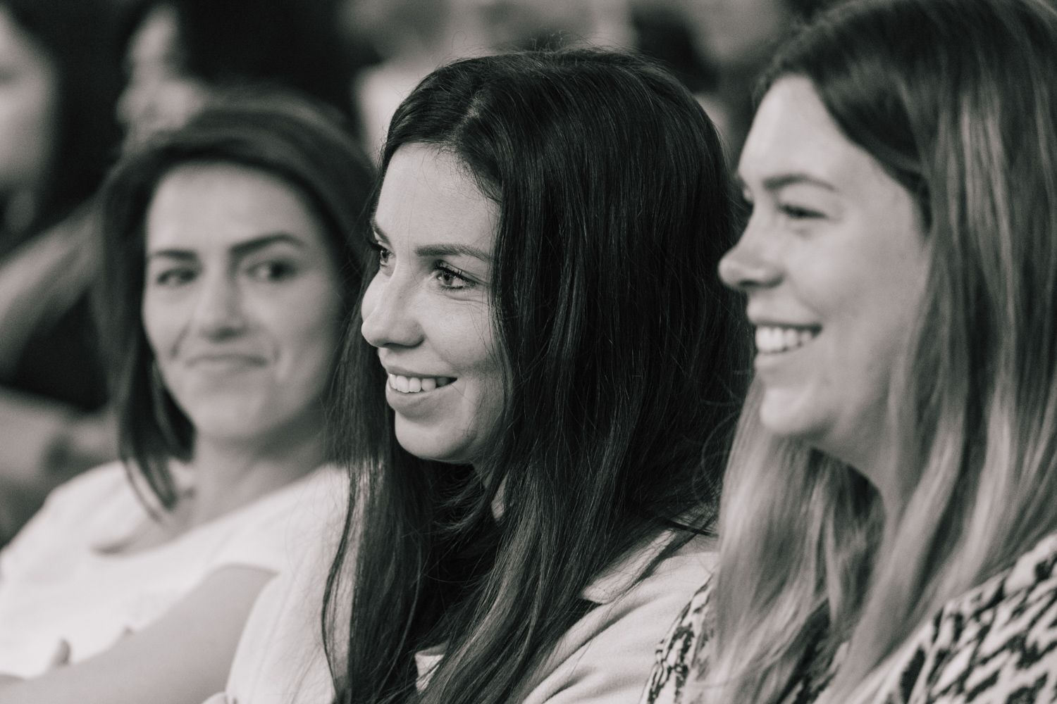 Audience members share genuine reactions during an engaging presentation.
