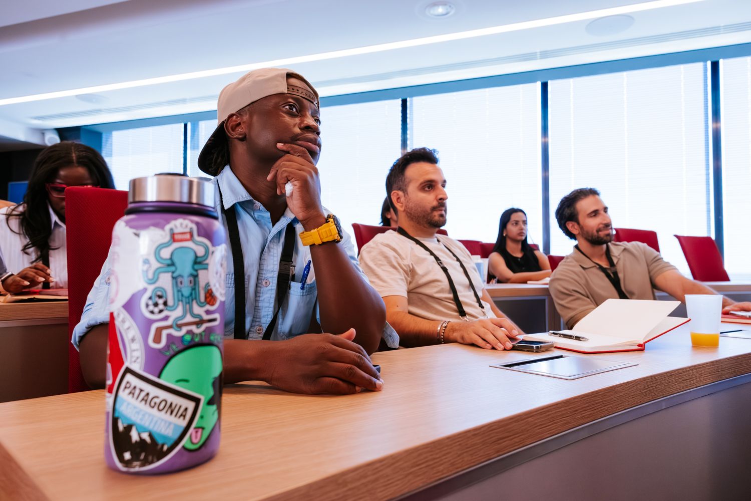 Students sitting at desks in a bright modern classroom during a learning session.