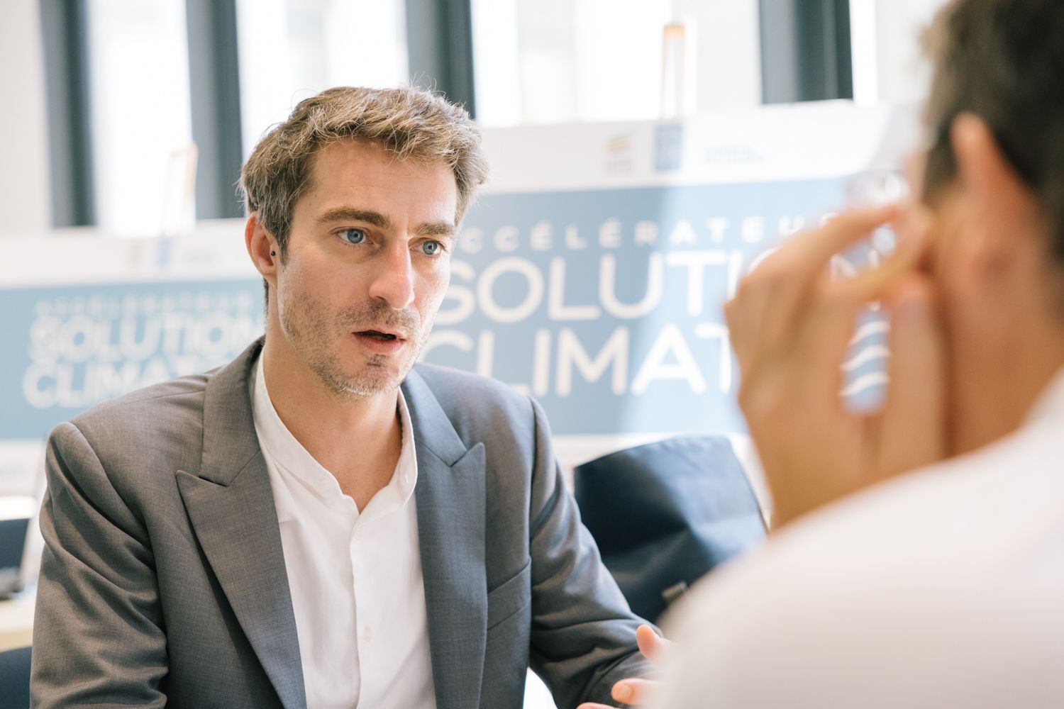 Business discussion taking place at Solutions Climate conference meeting.