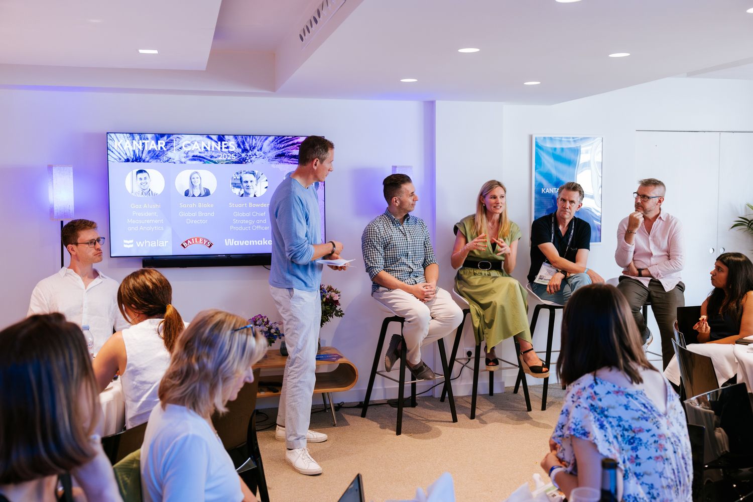 Attendees engage in an interactive discussion during a corporate training event in a bright meeting space.