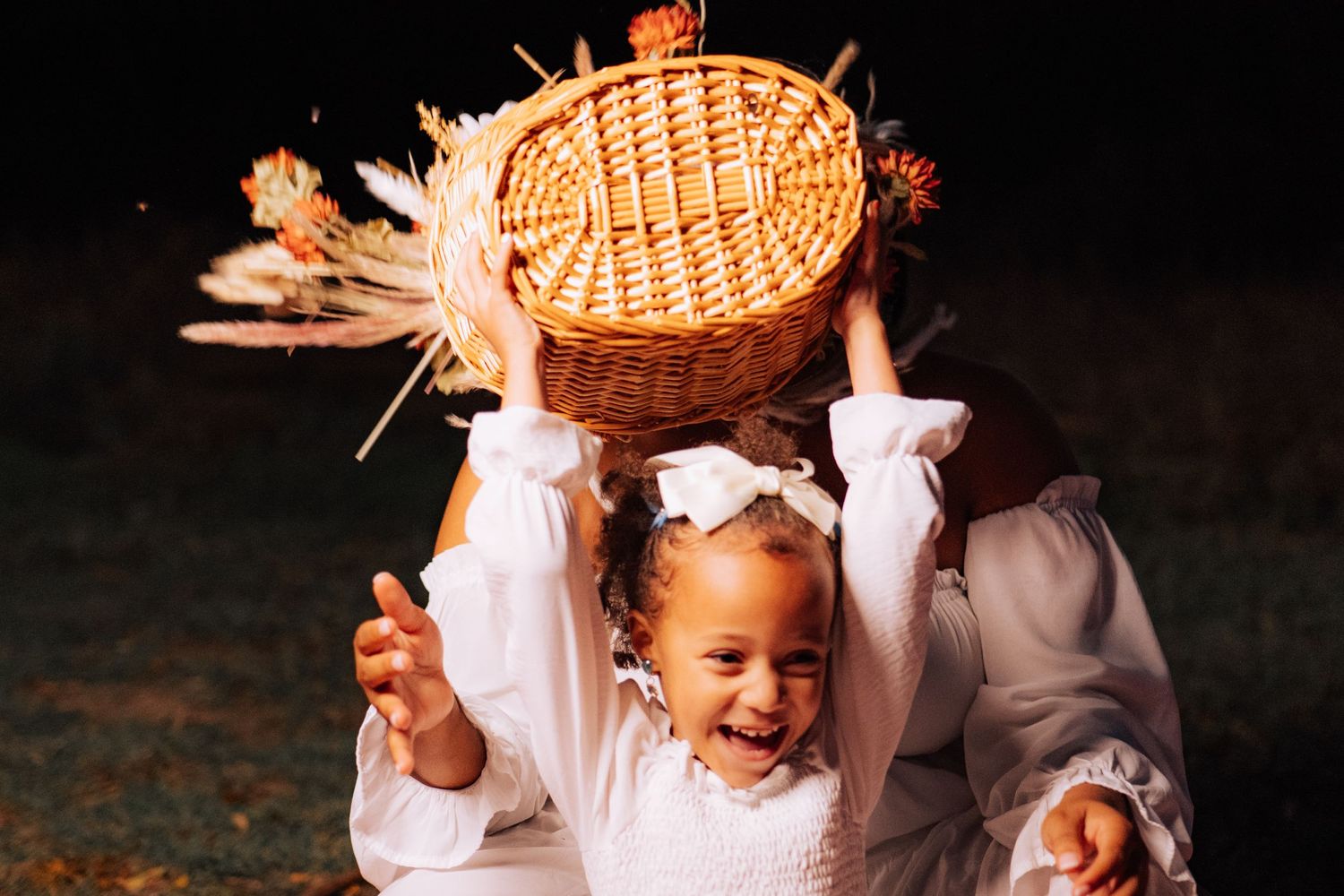 A cheerful scene with a wicker basket and white clothing at dusk.