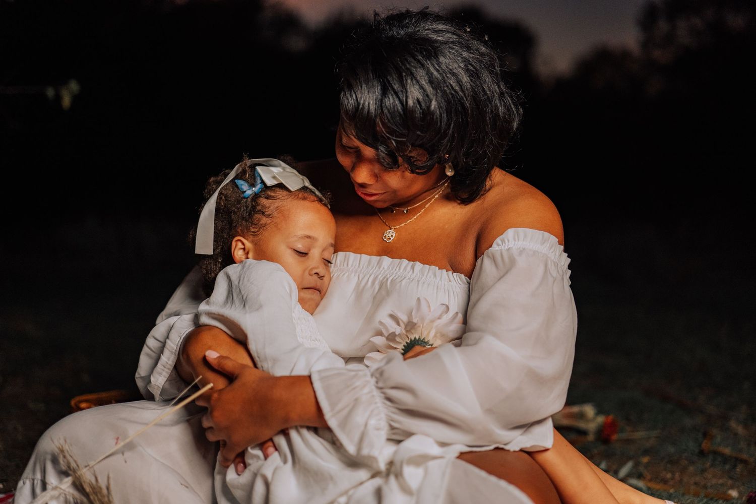An intimate outdoor portrait showcasing tender affection at sunset.