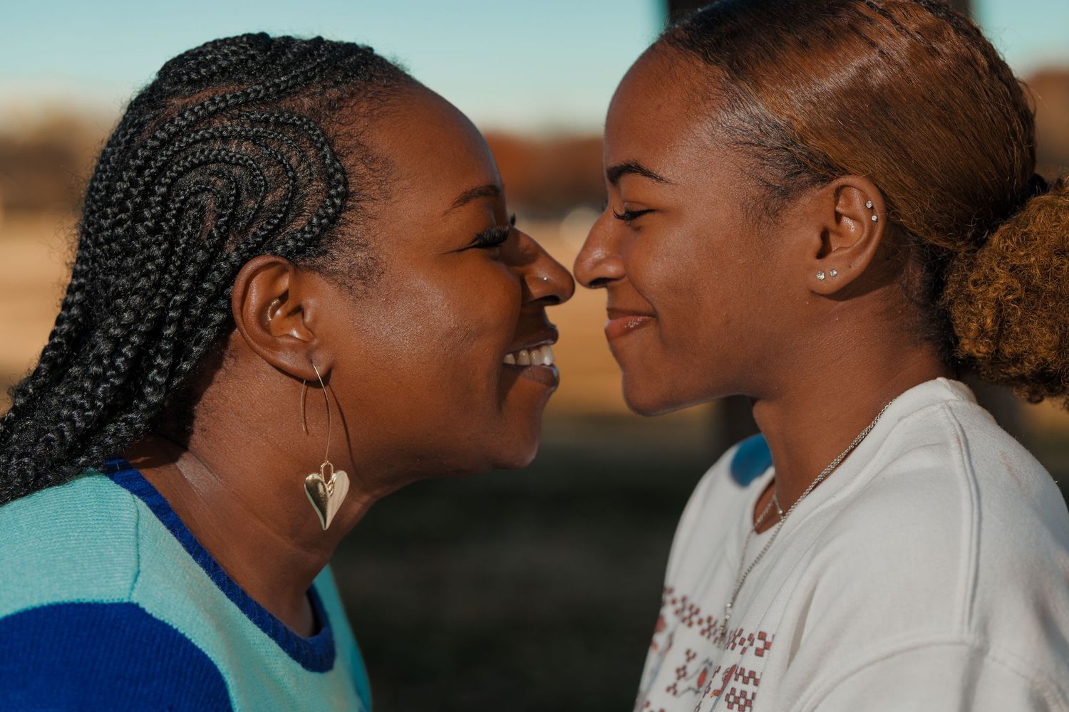 Two people sharing an intimate moment at sunset.