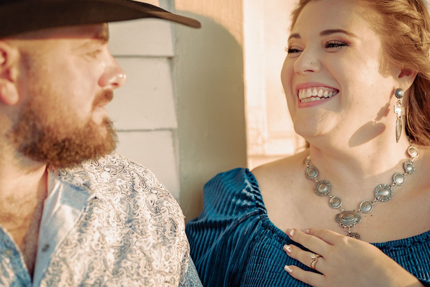 A joyful moment of laughter shared between two people in formal attire.