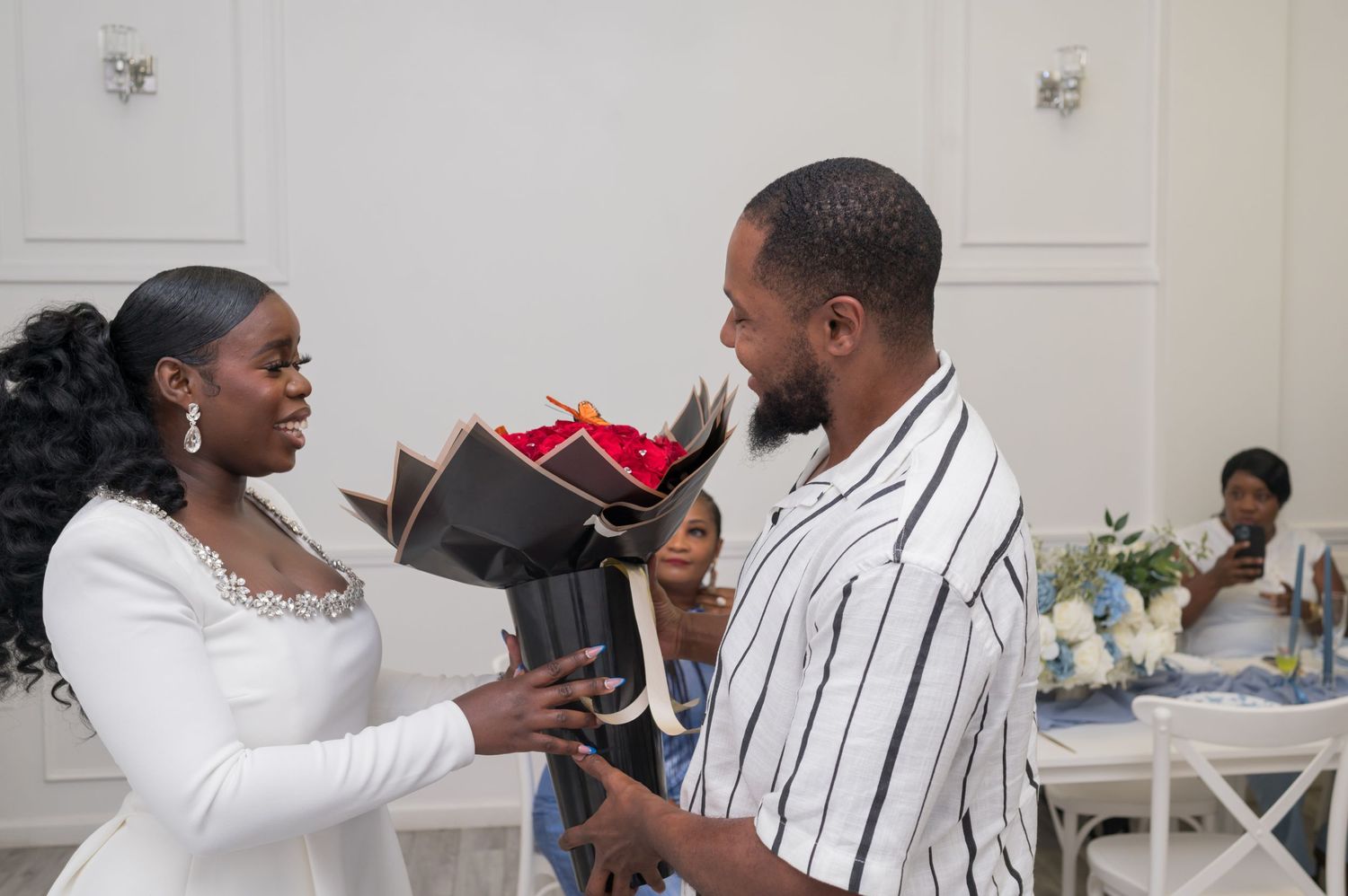 A couple examines shoes together during a bridal shower celebration.